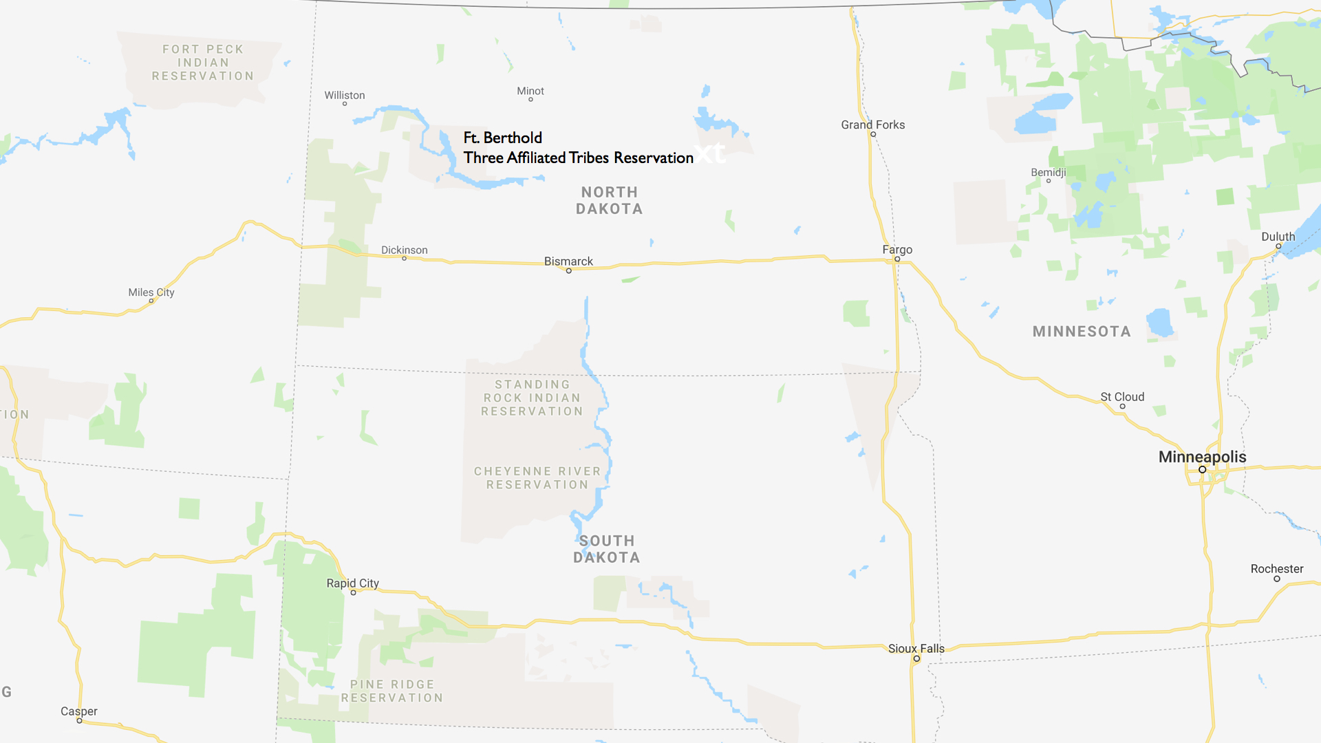 Map of present day North Dakota and surrounding states, with reservation lands indicated in light pink.